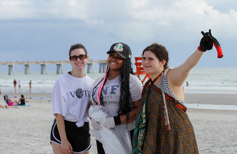 Students cleaning beach