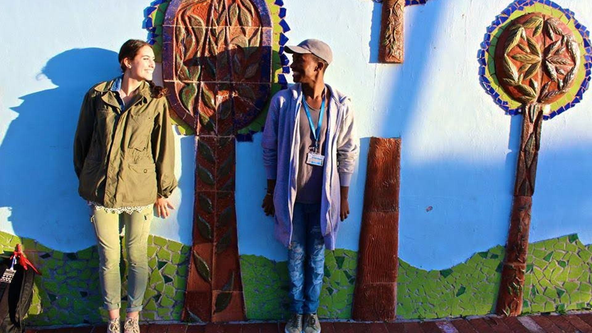 students standing in front of mural