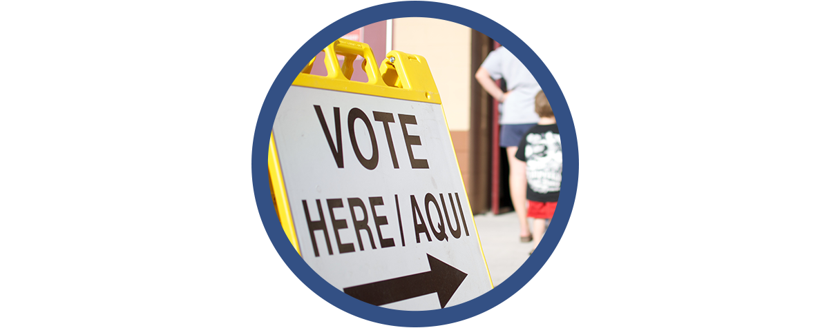 "vote here" sign at a polling place