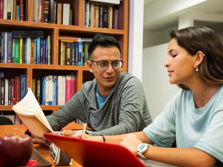 two people talking in a library