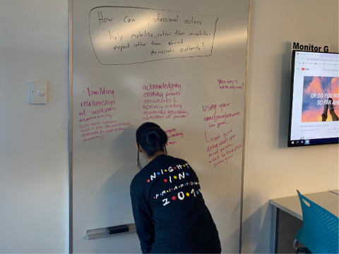 student writing on white board