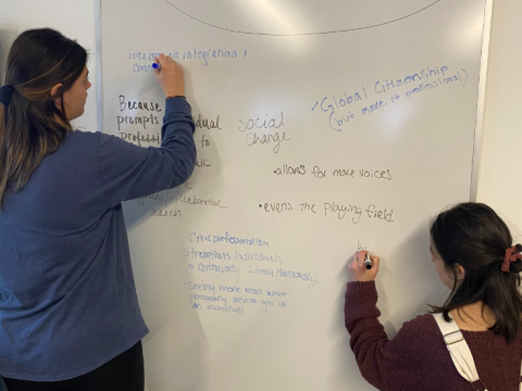 student writing on white board