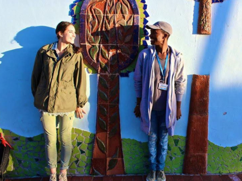 students standing in front of mural