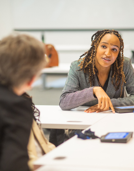 students talking while sitting at table