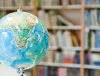 globe in front of a bookshelf