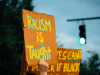 "racism is taught" protest sign